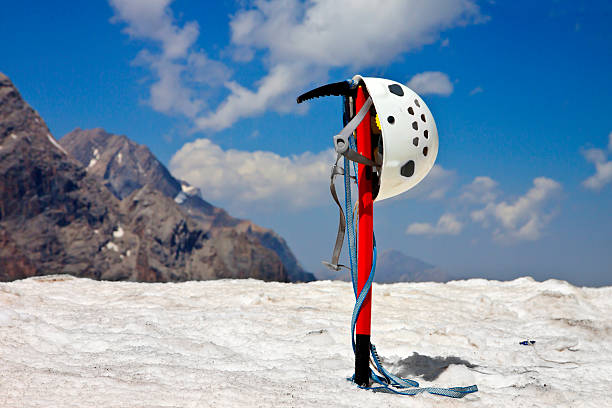 Climbing equipment in the mountains with snow and blue cloudy sky