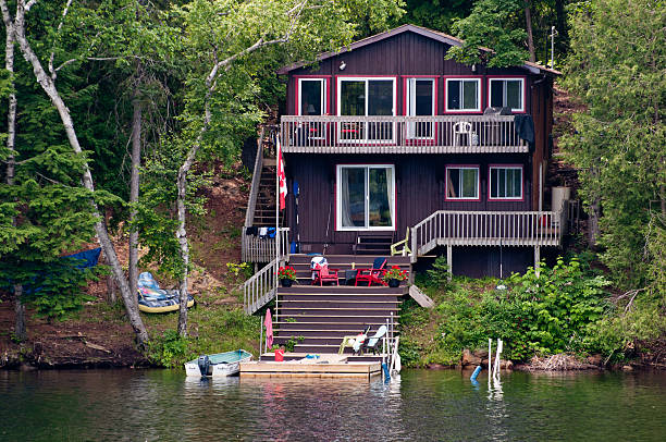 Cottage on the water Cottage with stairs leading to the water cottage stock pictures, royalty-free photos & images