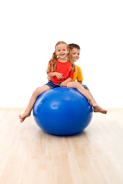 istock Kids having fun and exercises with a large ball 153500464