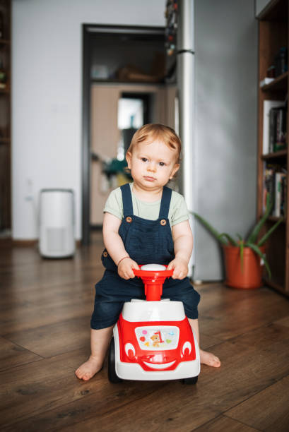 istock Charming little boy playing with his toy car at home. 1535005506