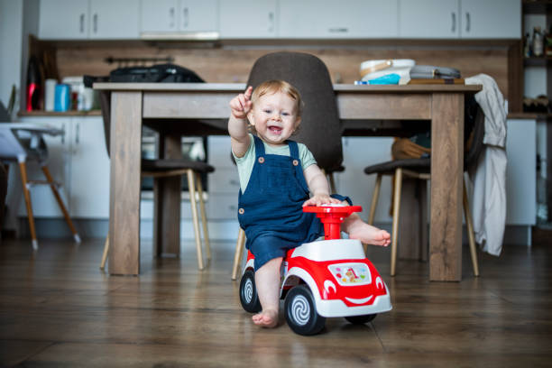 istock Charming little boy playing with his toy car at home. 1535005508