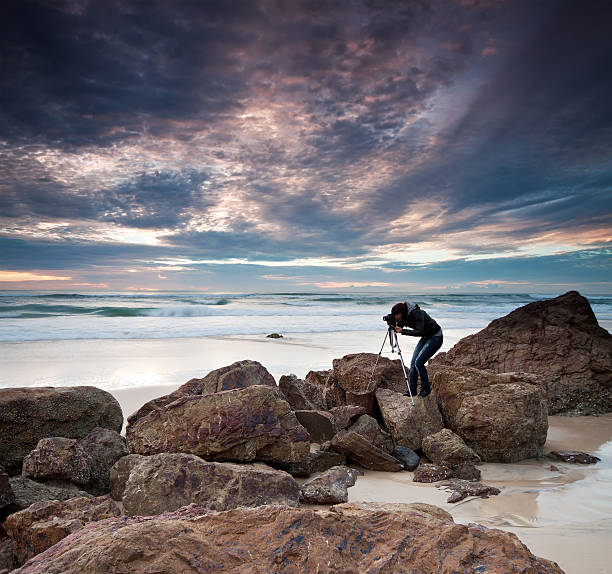 photographer by the ocean stock photo