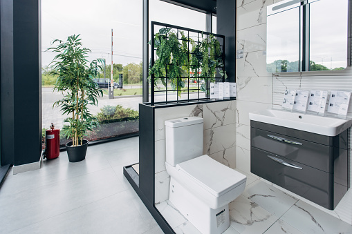 4k video, interior of a modern bathroom with a toilet and a sink with a white bedside table, close-up.