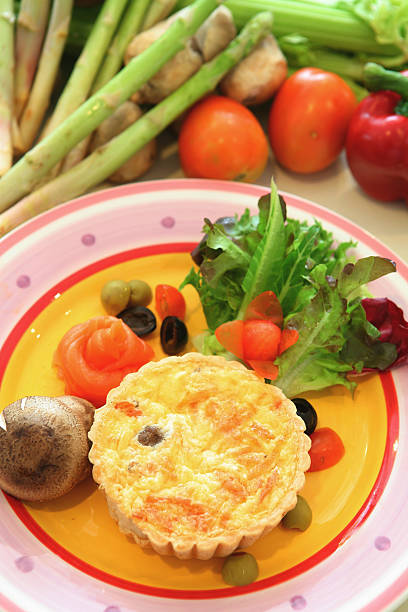 Pie of quiche on a colour plate. stock photo