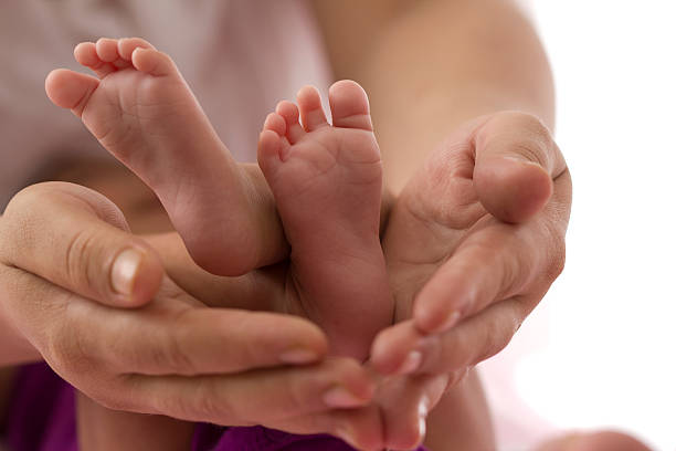 istock Newborn Baby's feet 153503909