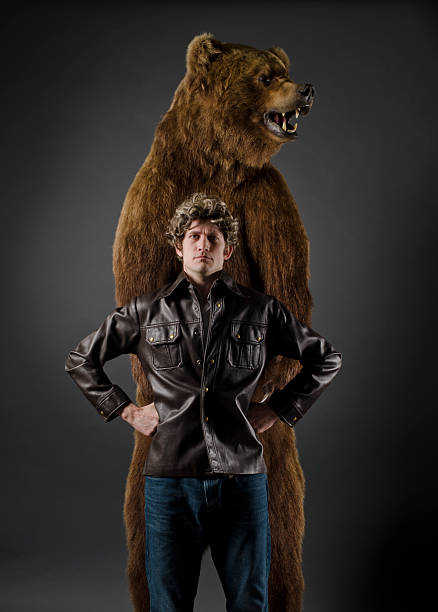 istock Defiant Man Standing with Grizzly Bear 153505590