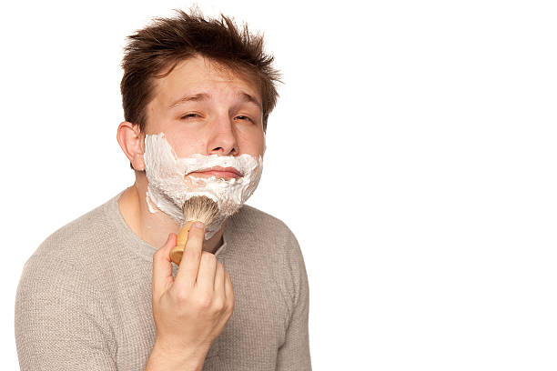 istock Man lathering on shaving cream white in studio 153505877