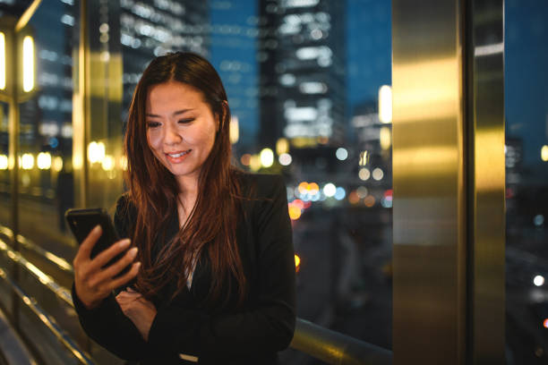 istock Beautiful Korean Female Using A Smart Phone At Night 1535059518