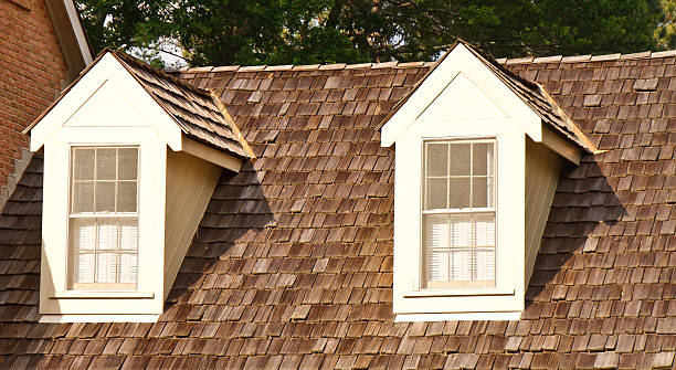 Two Dormers on Wood Shaker Roof Two windows in dormers on a wood shingle roof cedar stock pictures, royalty-free photos & images