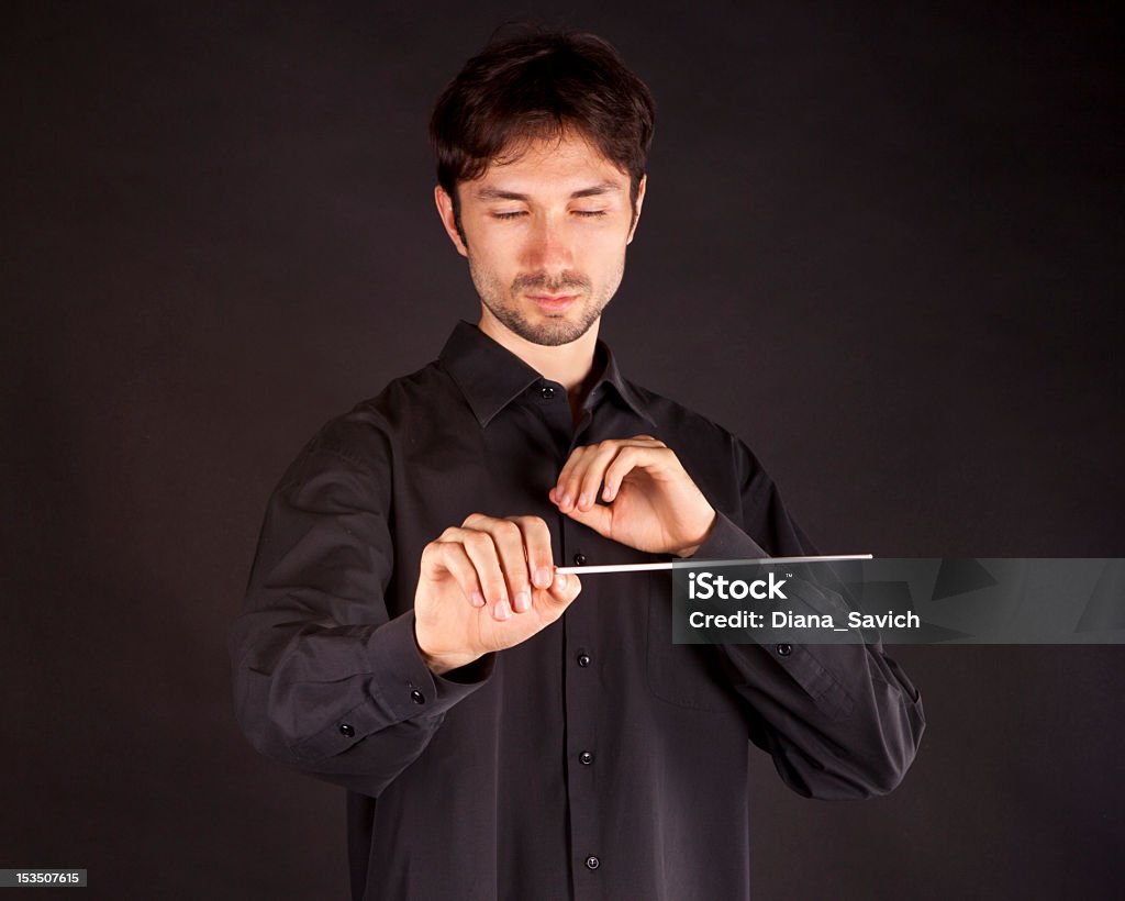 conductor conductor on a black background with a big inspiration gets the job done Orchestra Stock Photo