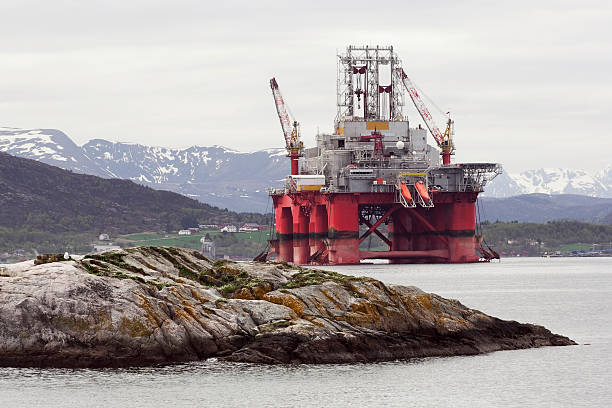 Oil rig in fjord landscape stock photo