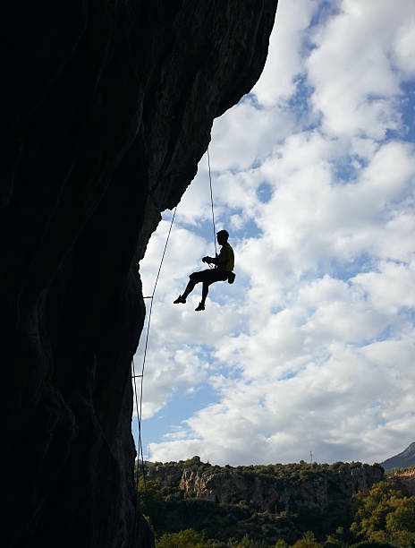 istock Silhouette of rock climber against cloudy sky background 153508147