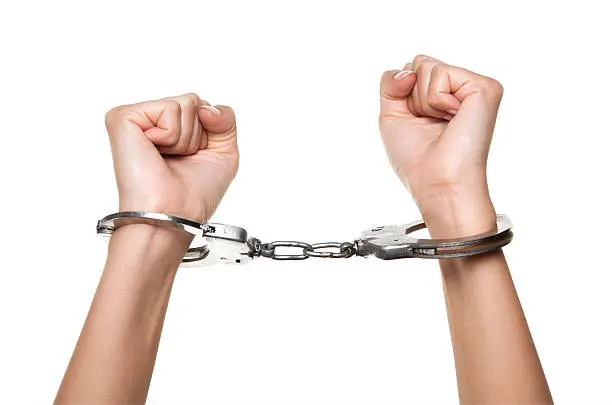 Handcuffed Woman Hands on Isolated White Background
