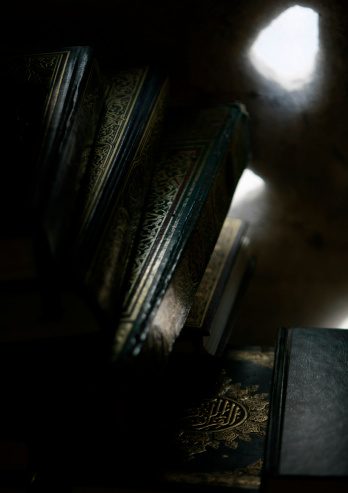 Copies of the Quarn, Koran are lit up by evening light at a Mosque.
