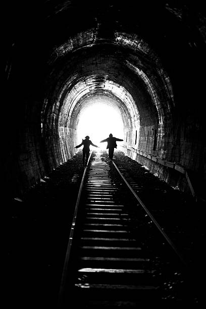 istock Man and woman going towards the light 153509399