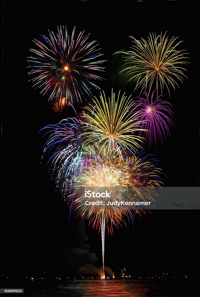 Beautiful colorful fireworks with night sky and lake reflections Abstract Stock Photo
