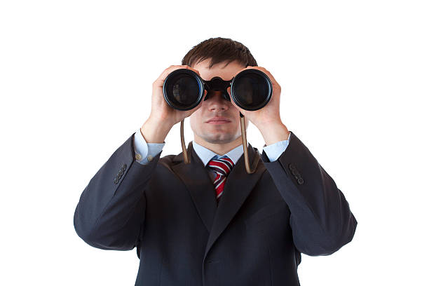 istock Young manager looks through binoculars and searches for business 153509572