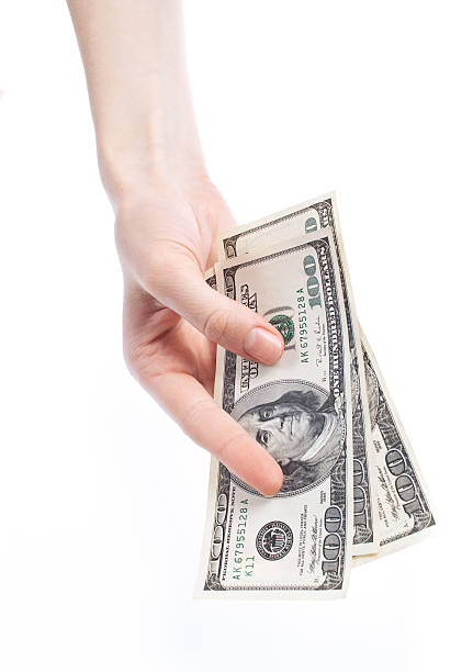 istock Hand giving dollars banknotes isolated on the white background 153509670