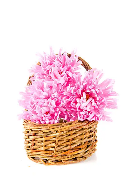 a wicker basket with pink flowers