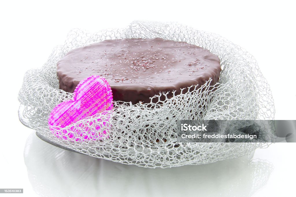 chocolate cake pretty decorated chocolate cake with pink heart and silver fabric Cake Stock Photo