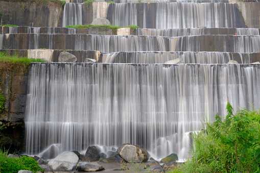 waterfall in slow speed photo. soft white waterfall. water flow. slow motion water in a rocky river