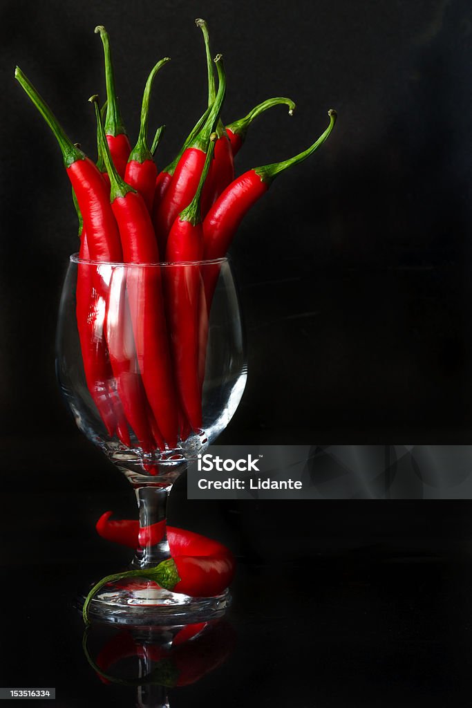 Chile. Hot chili in a wine glass on a black background. Backgrounds Stock Photo