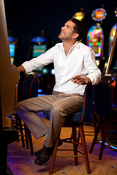 istock handsome man at the slot machine 153516962