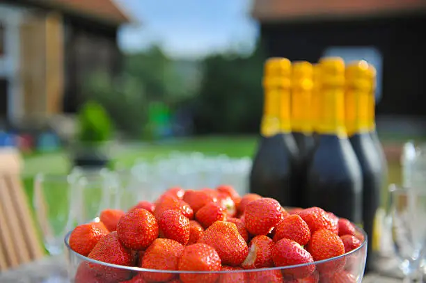A bowl of fresh strawberries and champagne