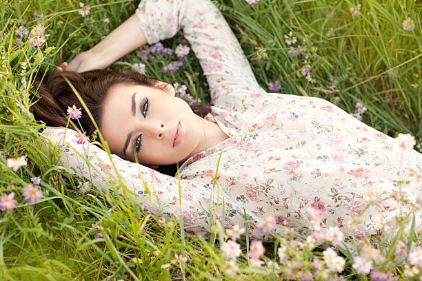 istock Beautiful, happy woman lying down on a grass. 153518661