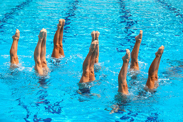 istock Synchronized swimmers with their feet in the air 153518995