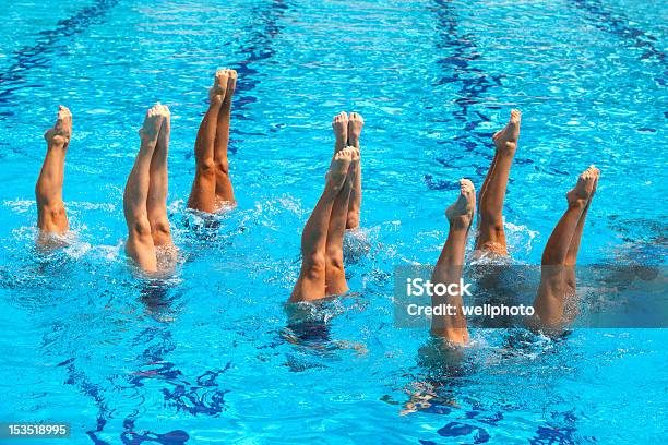 Synchronized Swimmers With Their Feet In The Air Stock Photo - Download Image Now - Artistic Swimming, Swimming, Sports Team