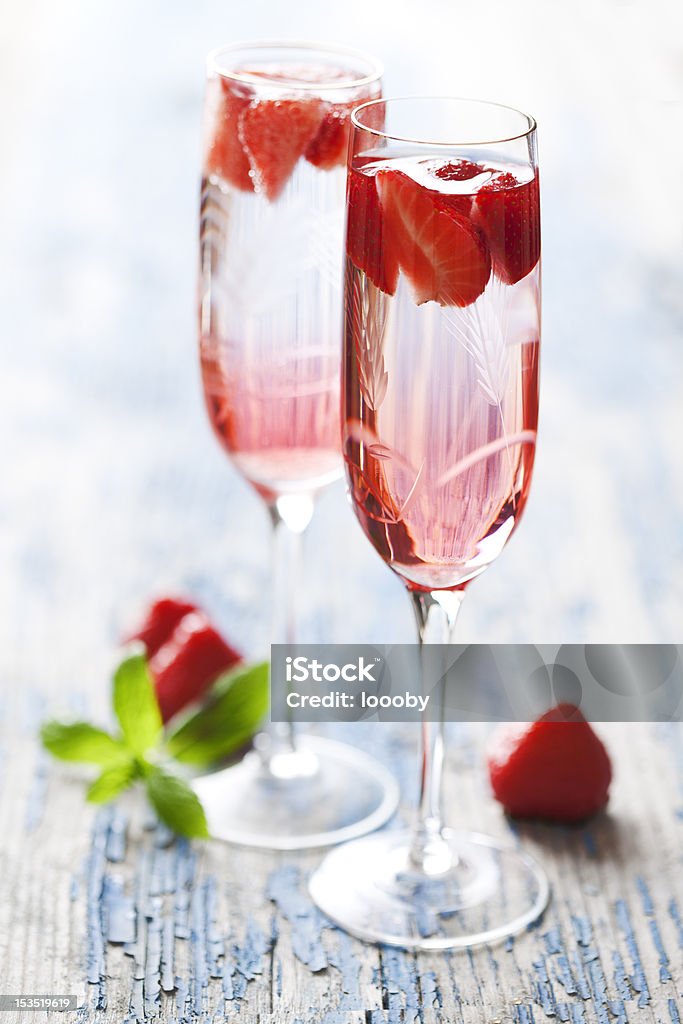 strawberry champagne cocktail to refreshing strawberry champagne cocktails on a rustic garden table Strawberry Stock Photo