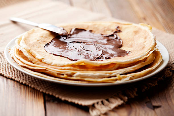 chocolate crepes stack og pancakes with chocolate spread crêpe pancake stock pictures, royalty-free photos & images