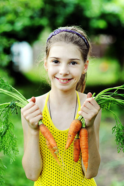 istock Girl with carrots 153520943