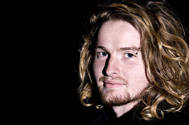 Teenager with long hair and pierced eye brow