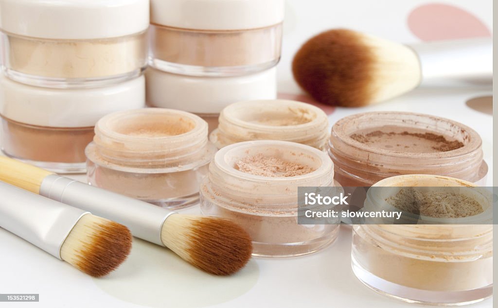Pots of make up with cosmetic brushes cosmetic brushes, make-up powder, blush, foundation, eyeshadow in plastic jars Applying Stock Photo