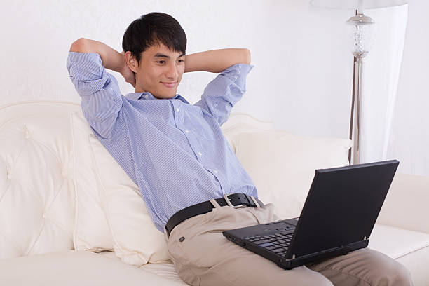 istock Handsome young man relaxing with hands behind head 153521386