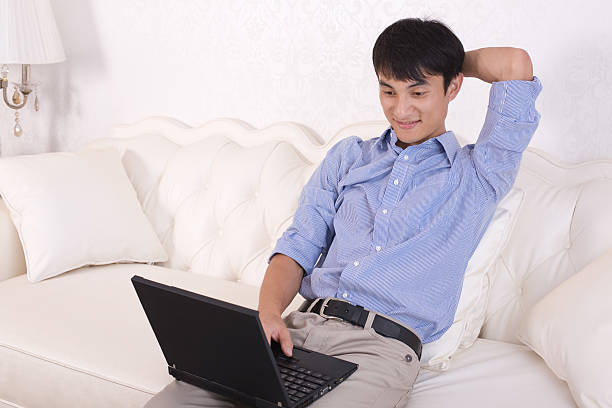 istock Handsome young man relaxing with hand behind head 153521410