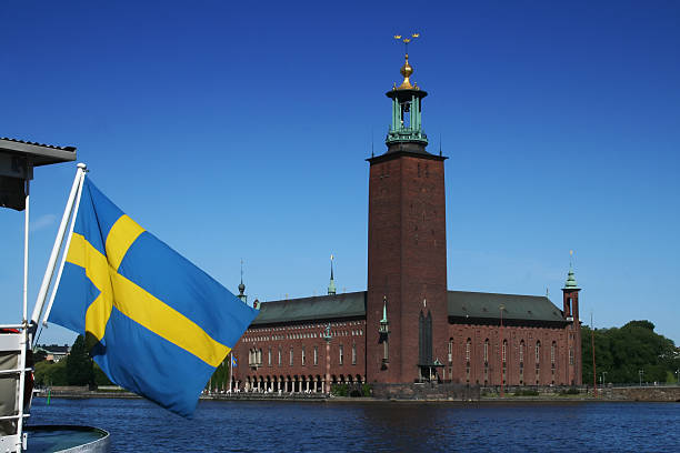 Stockholm, Sweden, city hall behind flattern sweden flag