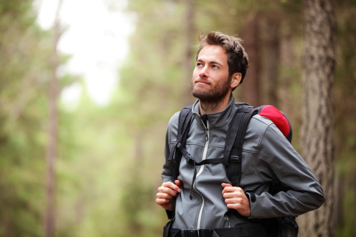 Hiker - man hiking in forest. Male hiker looking to the side walking in forest. Caucasian male model outdoors in nature. Click for :