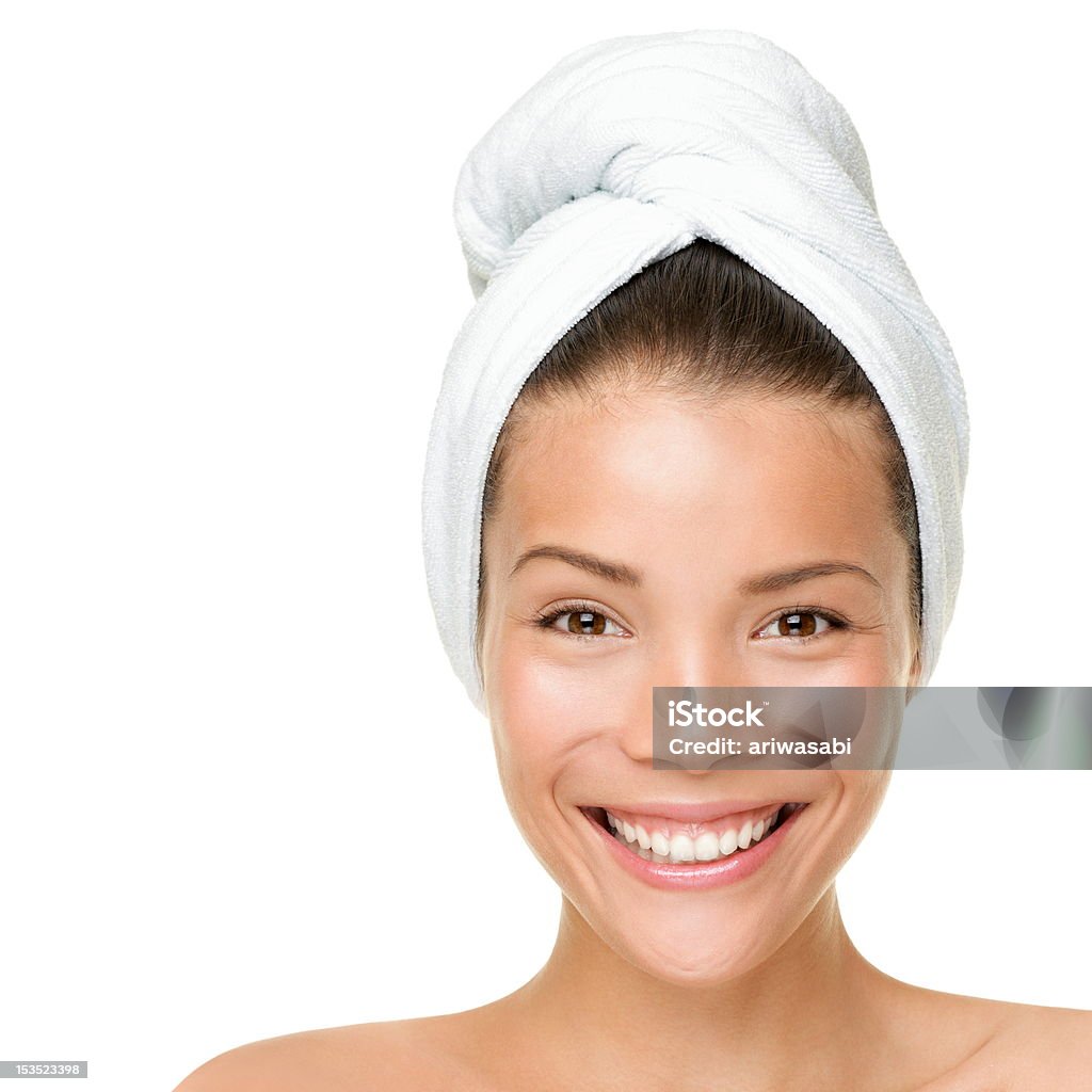 Beauty spa treatment woman Beauty spa treatment woman wearing towel drying hair. Closeup portrait of happy smiling beautiful Caucasian / Asian female model isolated on white background. Close-up Stock Photo