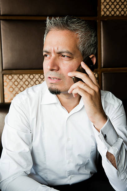 portrait of a young businessman on phone call stock photo