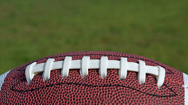istock Football Laces on Grass Background 153524907