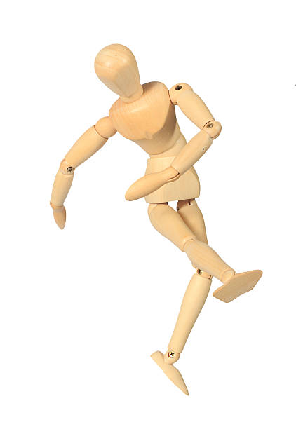 istock Yellow wooden dummy in kicking action 153525044