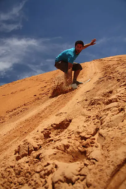 Man boarding on sand dune in Mui Ne - Viet - Nam