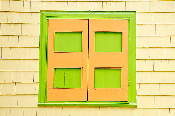 istock Green and Orange Shutters on Yellow Siding House 153526105
