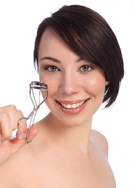 istock Smile by beautician woman using eye lash curler 153526331