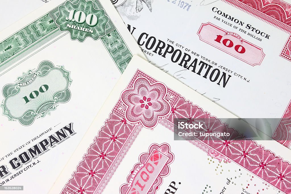 Corporate company stock shares Stock exchange collectibles. Old stock share certificates from 1950s-1970s (United States). Vintage scripophily objects (obsolete). Stock Certificate Stock Photo