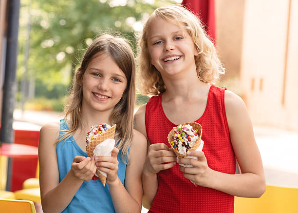 istock Kids enjoying ice cream with chocolate candy topping 153528207