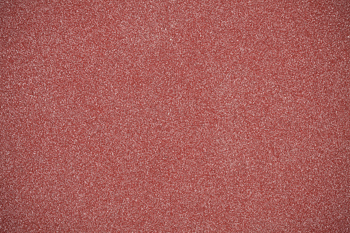 High resolution sand paper background with vignette effect.